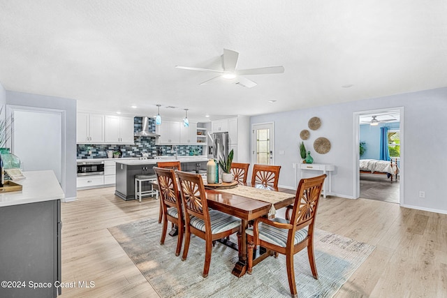 dining space with light hardwood / wood-style floors and ceiling fan