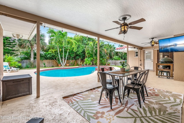 view of swimming pool with a patio and ceiling fan