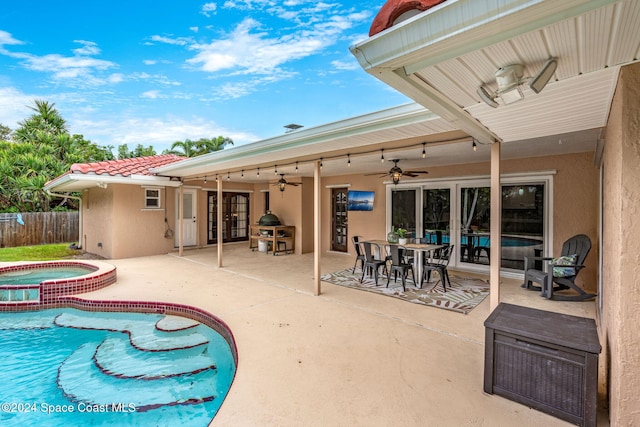 view of swimming pool with a patio area, an in ground hot tub, and ceiling fan