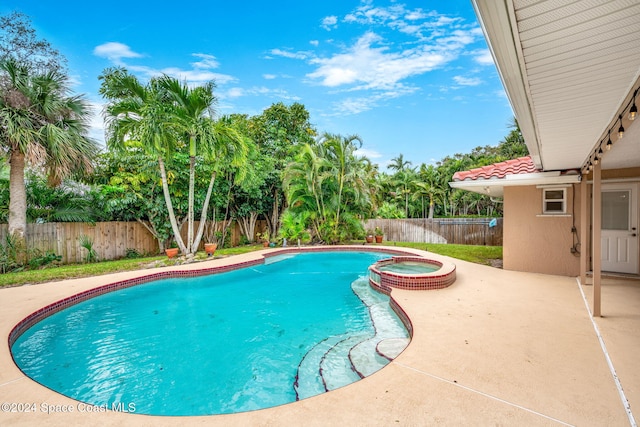 view of pool featuring a patio area and an in ground hot tub