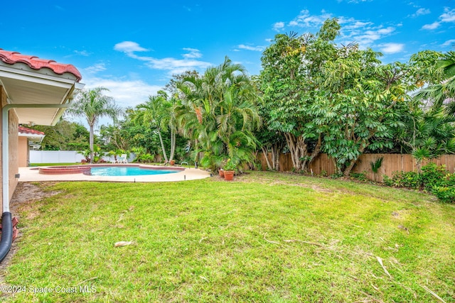 view of yard featuring a patio and a fenced in pool