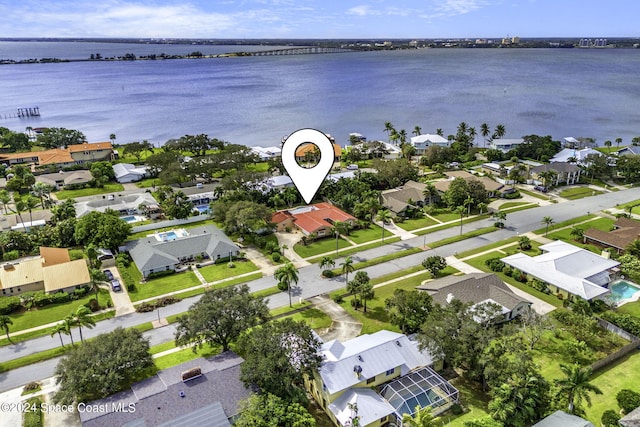 birds eye view of property with a water view