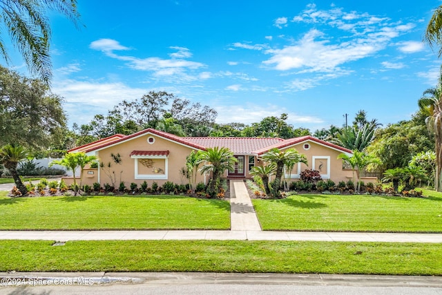 mediterranean / spanish house with a front yard