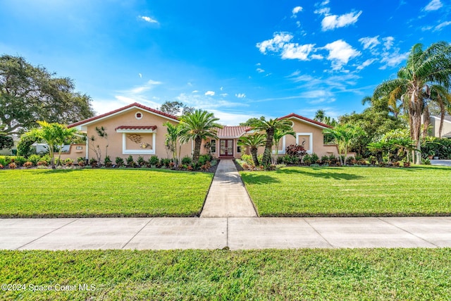 mediterranean / spanish house featuring a front yard