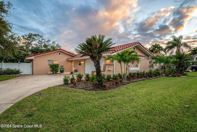 mediterranean / spanish house with a lawn