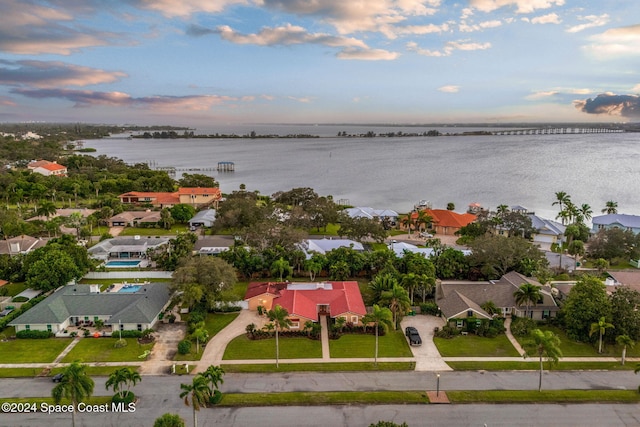 aerial view at dusk with a water view