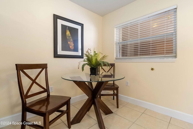 dining room featuring tile patterned floors and baseboards