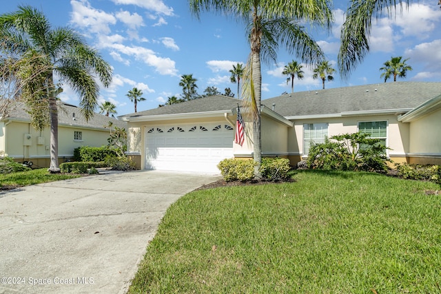 single story home with a front yard and a garage