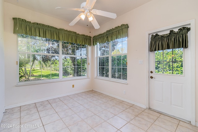 unfurnished sunroom with ceiling fan