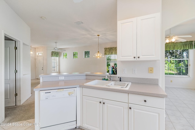 kitchen with dishwasher, kitchen peninsula, sink, pendant lighting, and white cabinets