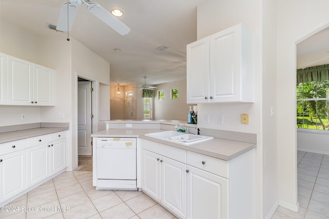 kitchen with white dishwasher, sink, kitchen peninsula, and a wealth of natural light