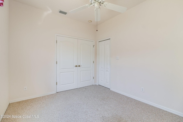 unfurnished bedroom featuring ceiling fan and light carpet