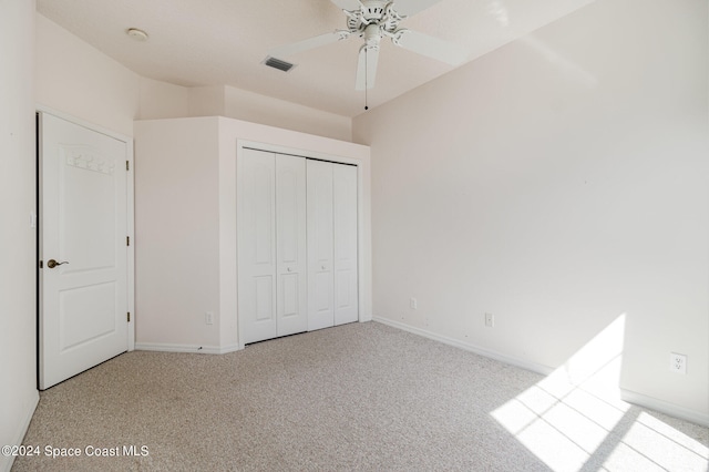 unfurnished bedroom with a closet, ceiling fan, and light carpet