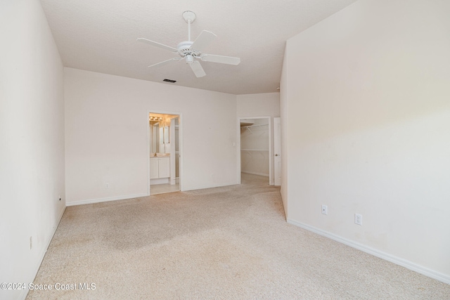 carpeted empty room featuring ceiling fan and a textured ceiling