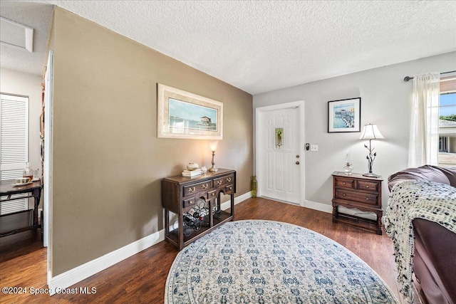 bedroom featuring dark wood-type flooring and a textured ceiling