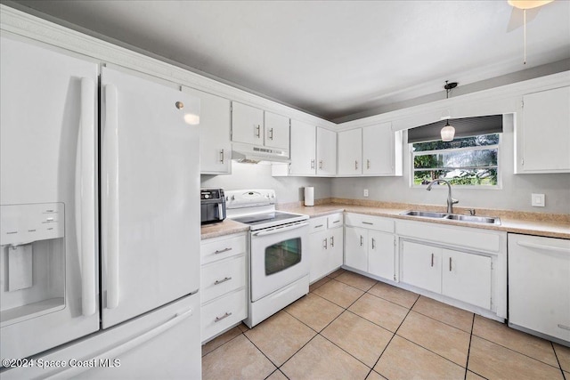 kitchen featuring sink, white cabinets, decorative light fixtures, and white appliances