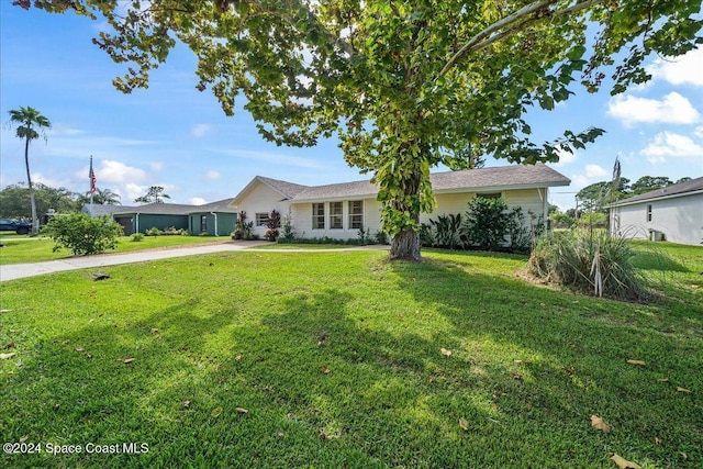 ranch-style house with a front lawn