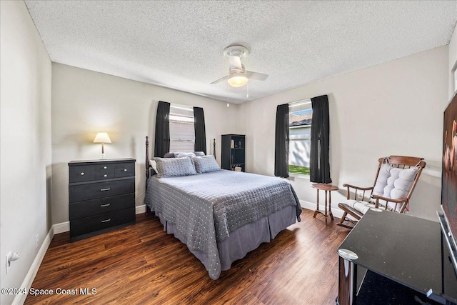 bedroom featuring a textured ceiling, ceiling fan, and dark hardwood / wood-style floors