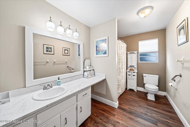 bathroom with vanity, wood-type flooring, and toilet