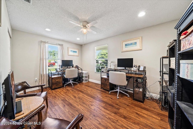 office featuring dark hardwood / wood-style floors, a healthy amount of sunlight, and a textured ceiling