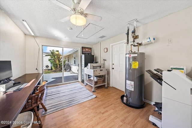 office featuring light wood-type flooring, a textured ceiling, electric water heater, and ceiling fan