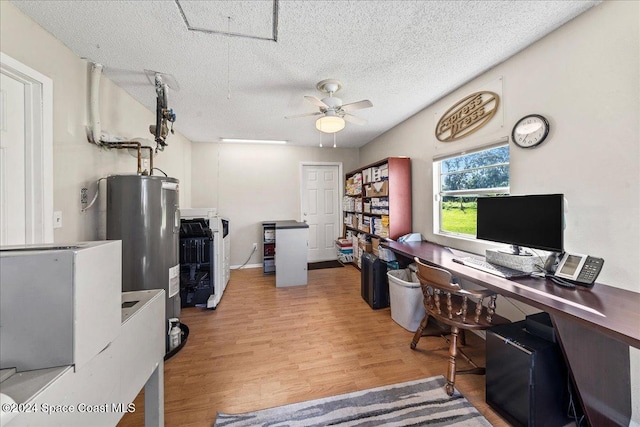 office featuring hardwood / wood-style flooring, ceiling fan, a textured ceiling, water heater, and washer / dryer