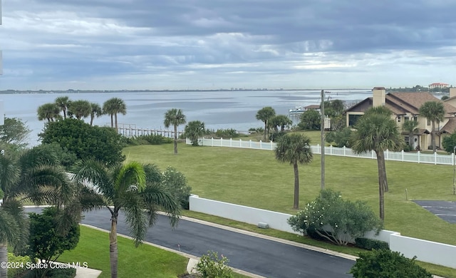 view of property's community featuring a yard and a water view