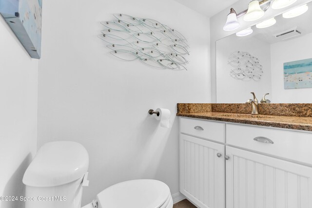 bathroom featuring vanity and toilet