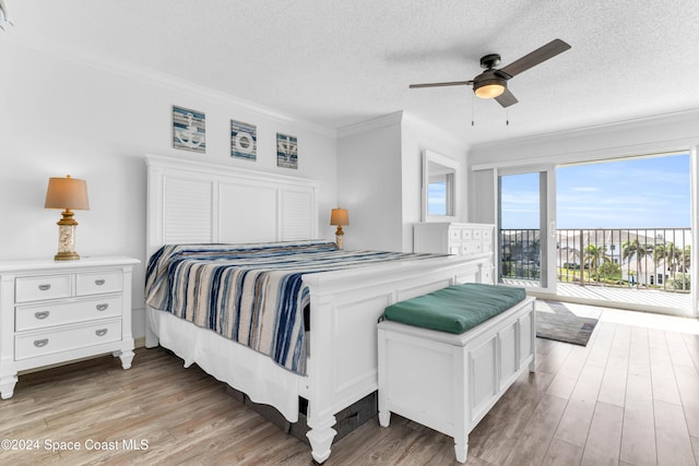 bedroom with access to outside, ceiling fan, light wood-type flooring, a textured ceiling, and ornamental molding