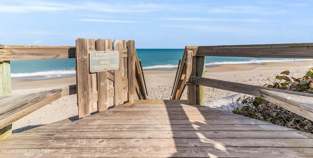 view of home's community with a beach view and a water view