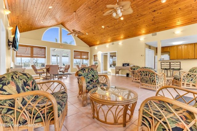 living room with ceiling fan, light tile patterned floors, and high vaulted ceiling