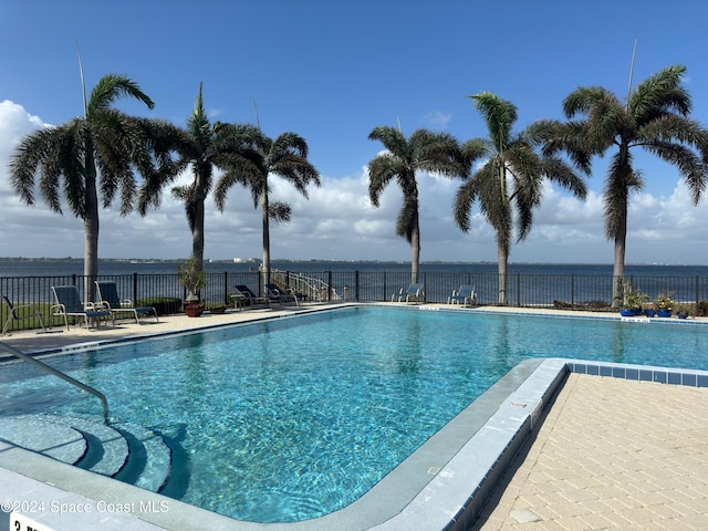 view of swimming pool with a water view