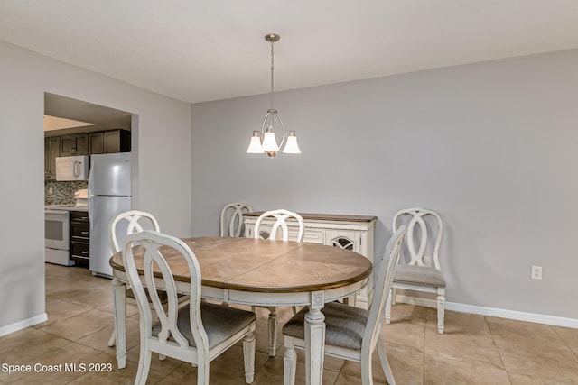 tiled dining space with an inviting chandelier