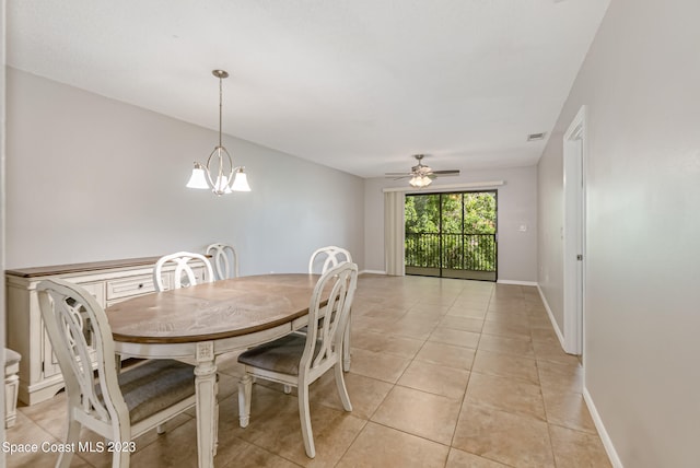 dining room with ceiling fan with notable chandelier and light tile patterned floors