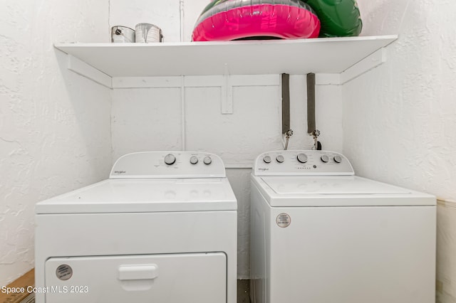 clothes washing area featuring washer and clothes dryer