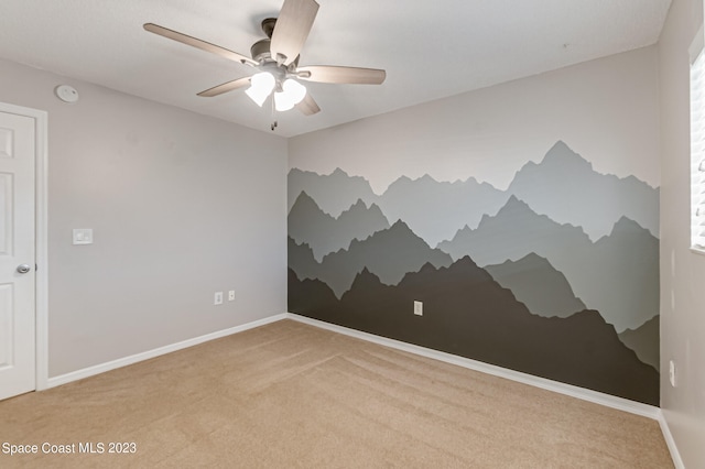 empty room with light carpet and ceiling fan