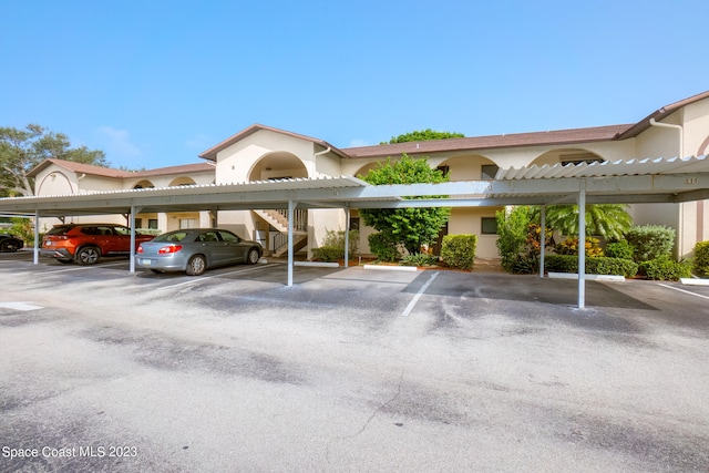 view of parking / parking lot featuring a carport