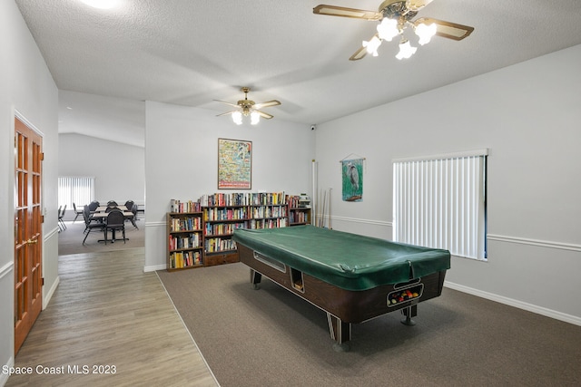 recreation room with pool table, wood-type flooring, vaulted ceiling, a textured ceiling, and ceiling fan