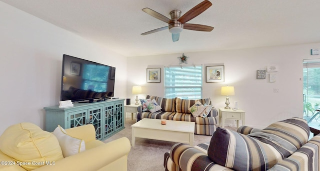 carpeted living room featuring ceiling fan