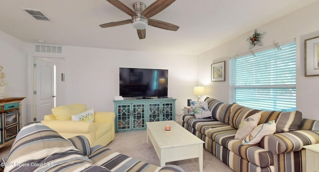 carpeted living room featuring ceiling fan