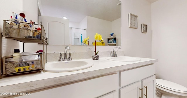 bathroom featuring vanity, toilet, and a shower with door