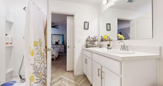 bathroom with vanity, ceiling fan, parquet floors, and curtained shower