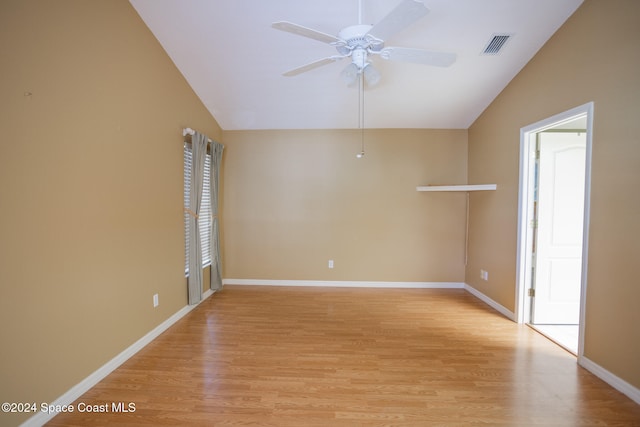 spare room featuring lofted ceiling, ceiling fan, and light wood-type flooring