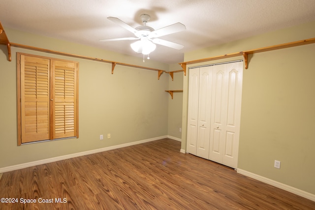 unfurnished bedroom featuring a textured ceiling, hardwood / wood-style flooring, a closet, and ceiling fan