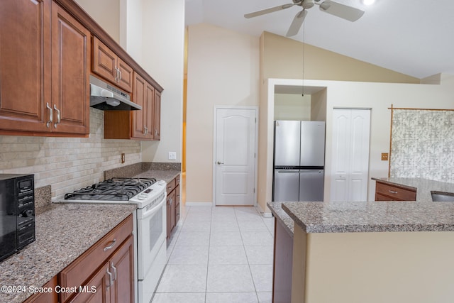 kitchen featuring stainless steel fridge, light tile patterned floors, white range with gas cooktop, and vaulted ceiling