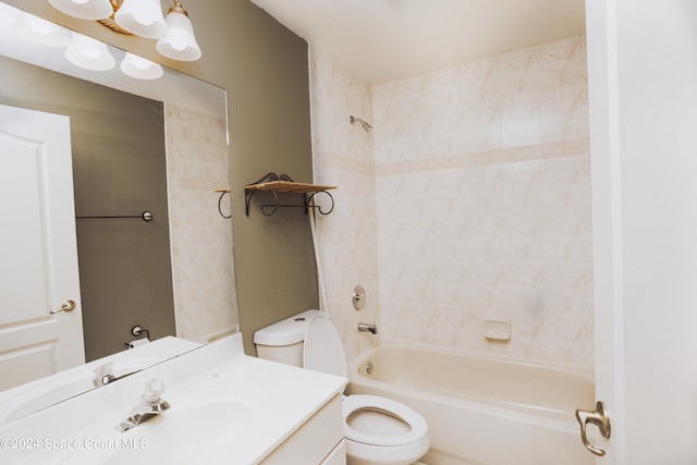 full bathroom with vanity, tiled shower / bath, and toilet