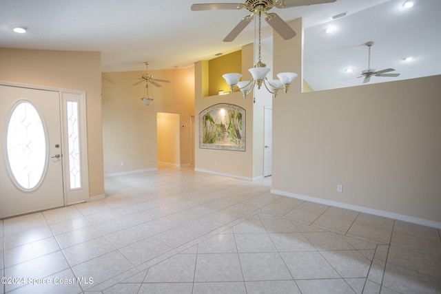 tiled foyer with high vaulted ceiling and ceiling fan with notable chandelier