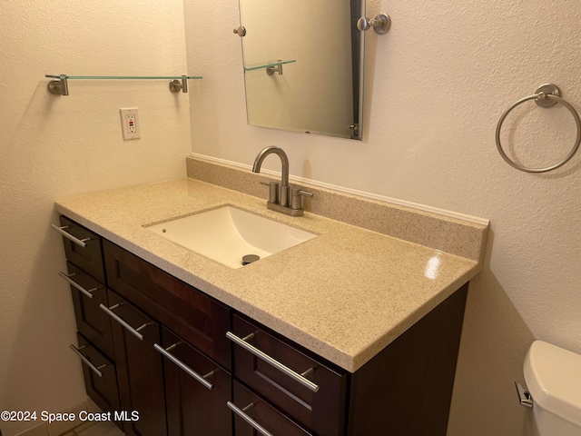 bathroom featuring vanity and toilet