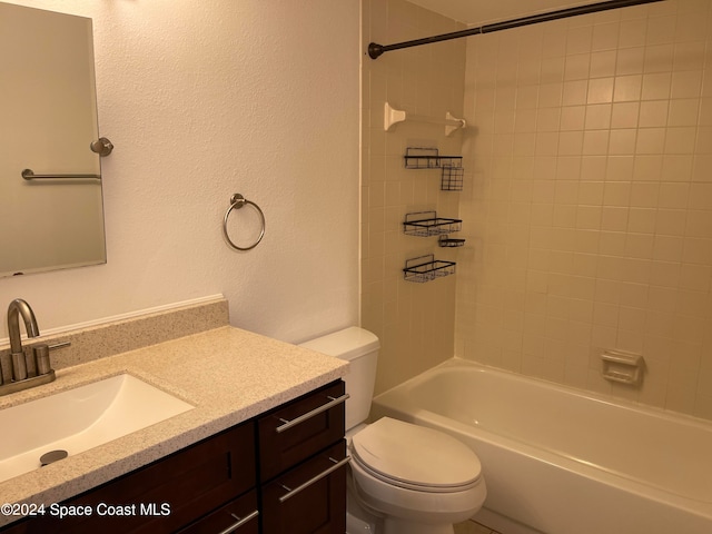 full bathroom featuring vanity, toilet, and tiled shower / bath combo