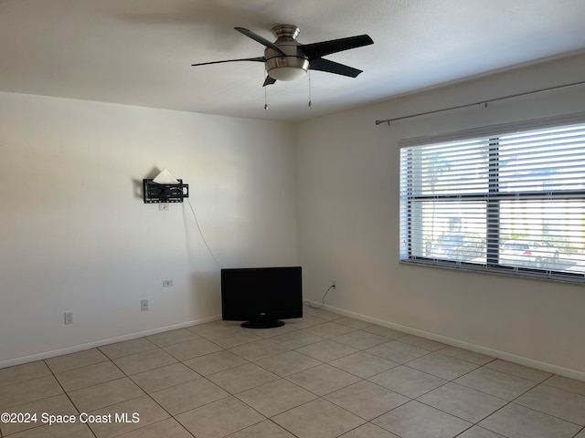 tiled empty room with ceiling fan